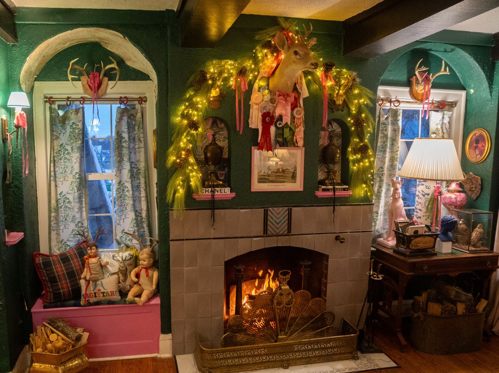 A maximalist fireplace decorated for Christmas